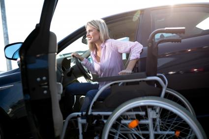 Photo of woman transferring from wheelchair to vehicle
