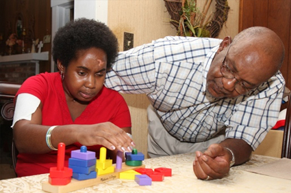 Father teaching child with blocks