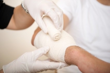 hand being bandaged