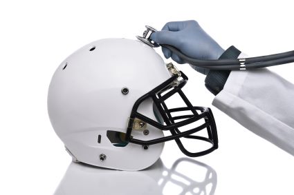 Stethoscope held to a football helmet