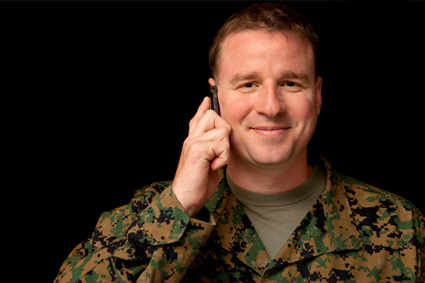 Person in fatigues on the phone