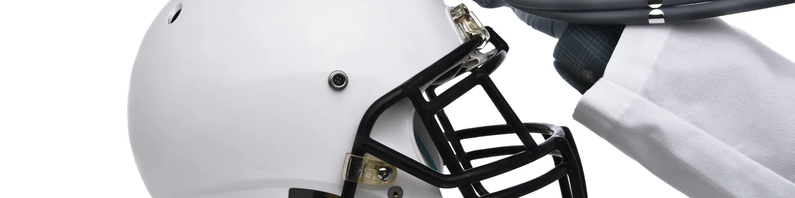 Doctor holding stethoscope up to football helmet