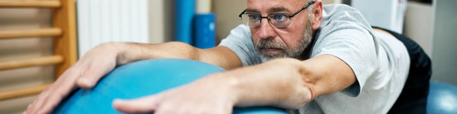 Man practicing balancing with exercise ball