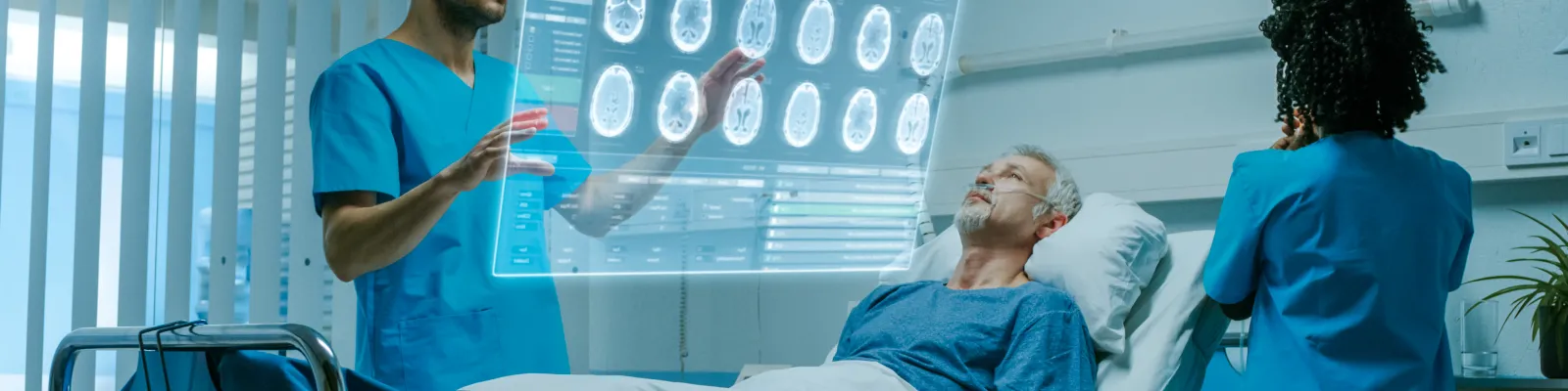Photo of patient in hospital room with clinicians looking at brain scans