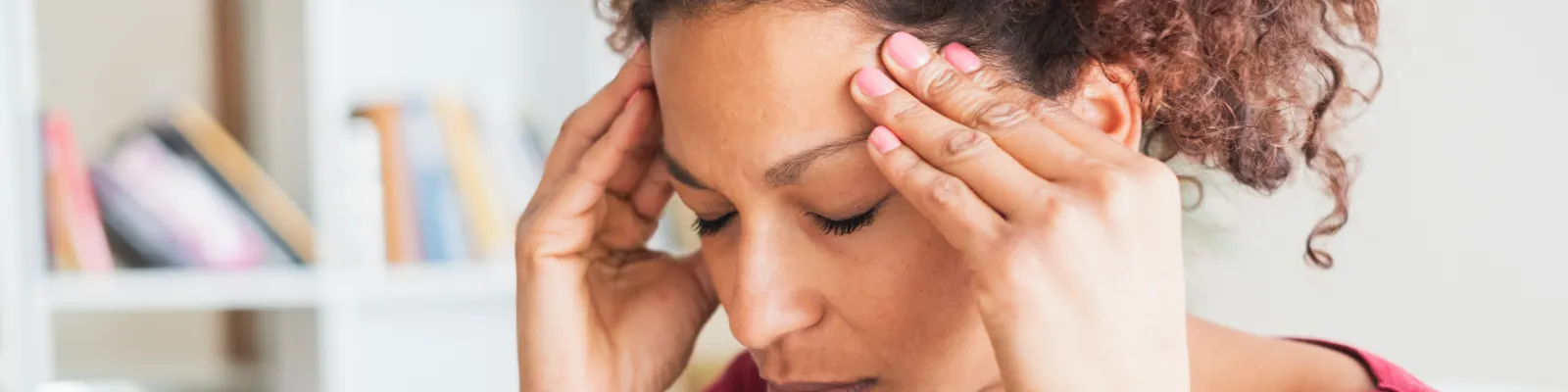 Photo of woman holding her head