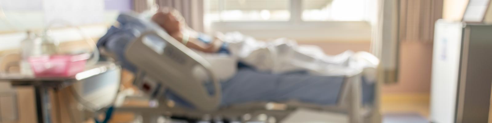 Blurred photo of patient in hospital bed
