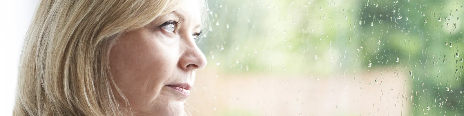 Photo of woman looking out of a window