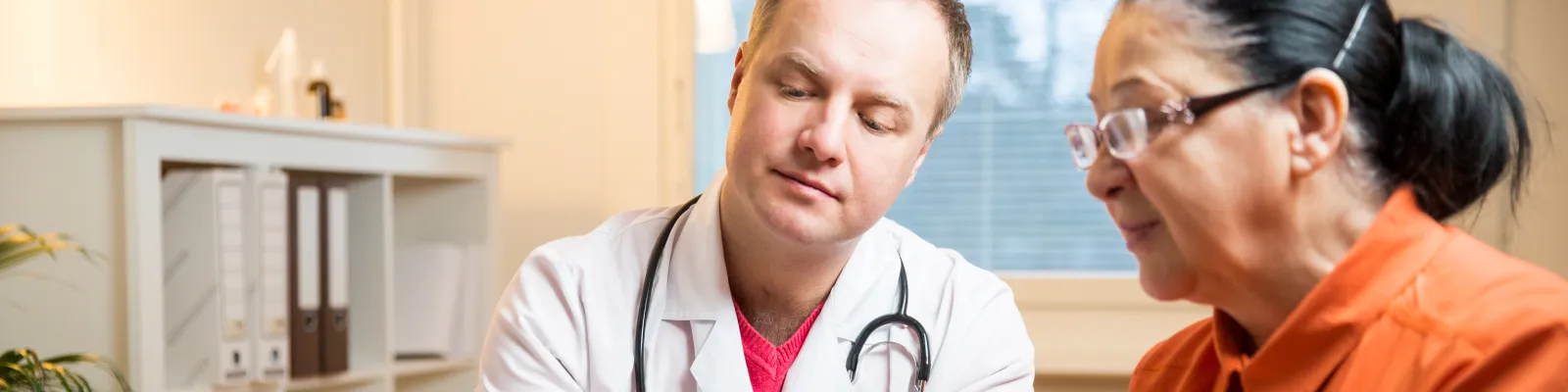 Photo of patient and clinician looking at a tablet