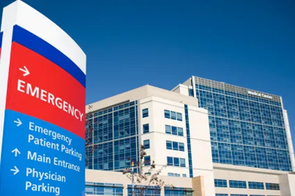 Front entrance of a hospital showing Emergency sign