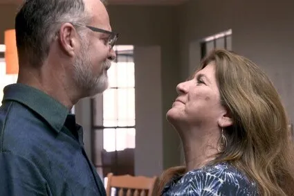 Couple looking lovingly in each others eyes.