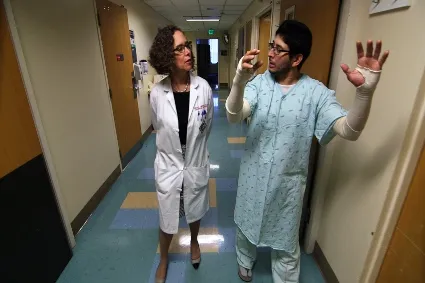 Patient and doctor walking down a hallway
