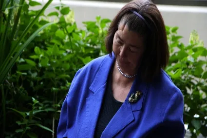 Woman in blue blazer looking away