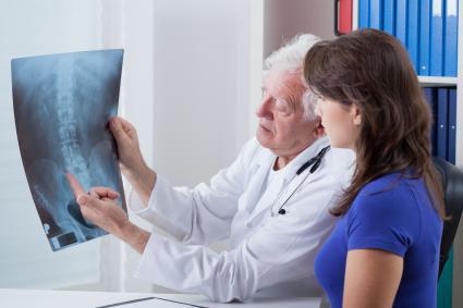 doctor showing x-ray to patient
