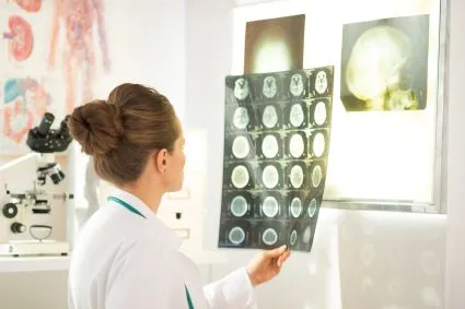 Clinician looking at brain scans