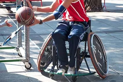 Man in wheelchair playing basketball