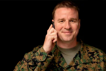 Person in fatigues on the phone