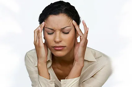 Person rubbing their temples to relieve headache pain