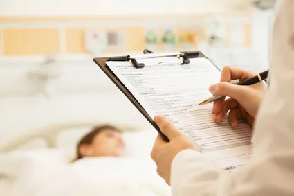 Doctor making notes in patient's chart