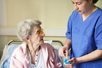 Nurse assisting woman