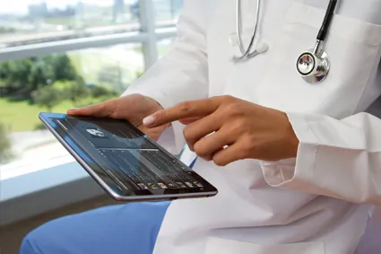Doctor looking at information on tablet