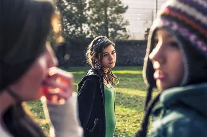 Person looking at two other people having a conversation