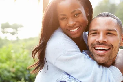 Couple laughing in a field