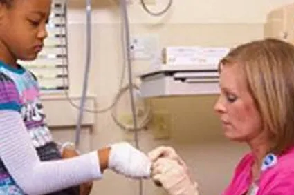 Person tending to child's bandages