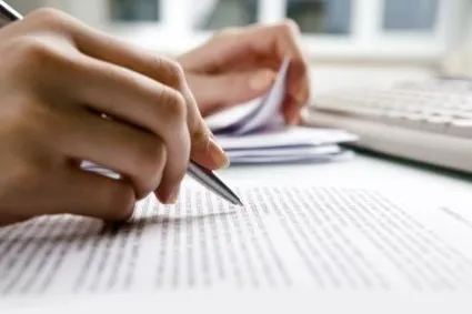 Pair of hands writing on paper