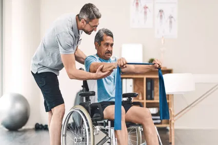 Man in wheelchair doing band exercises