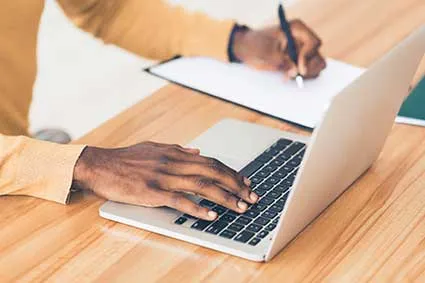 Person taking an online course on a laptop