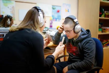 Speech language pathologist with young boy