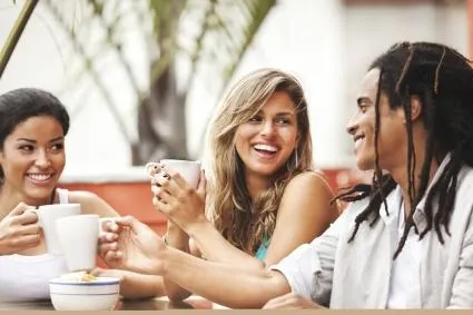 Three people conversing and smiling