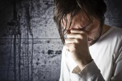 Man holding his head in hand