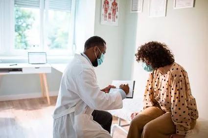 Doctor reviewing chart with mask on
