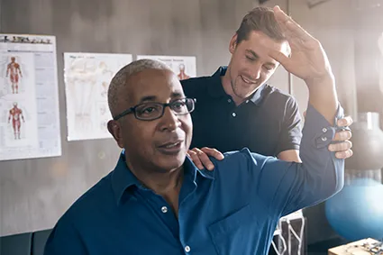 Physical therapist working with a man