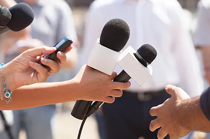 Microphones pointing at person in interview