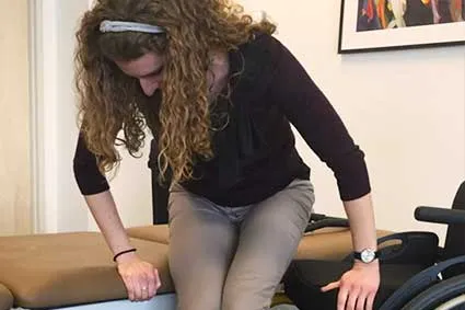 Woman making a safe wheelchair transfer