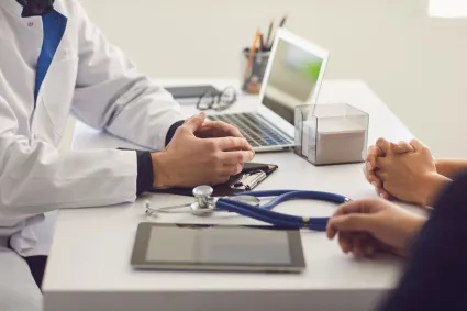 Photo of people speaking with doctor