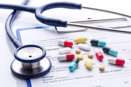 Photo of variety of pills with a stethoscope