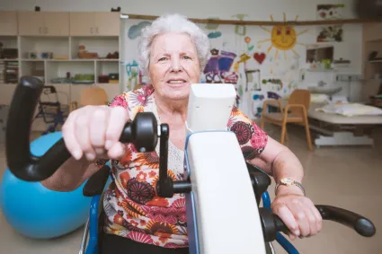 Photo of woman using stationary hand bike