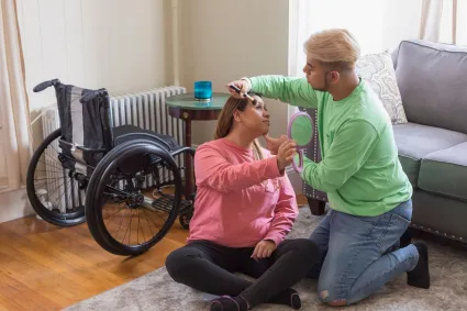Photo of woman with SCI being helped by family member