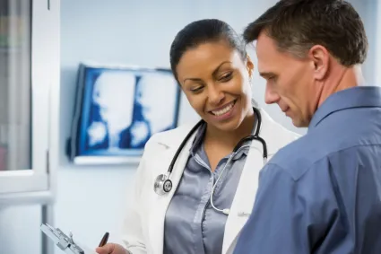 Photo of clinician staff speaking to a patient