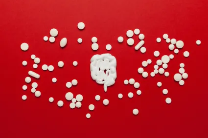 Illustration of bowels surrounded by pills