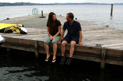 Photo of couple talking on a dock
