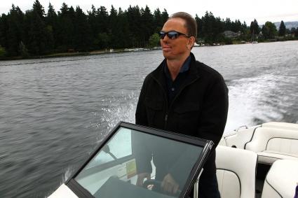 Photo of Ben driving a boat