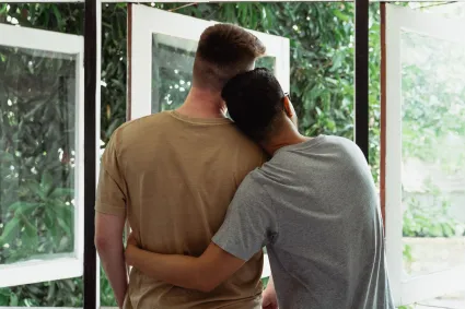 Photo of couple looking out a window