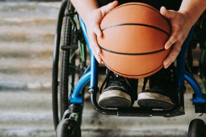 Photo of person in wheelchair holding basketball