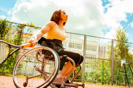 Photo of woman in wheelchair playing tennis