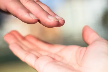 Photo of two hands reaching toward each other