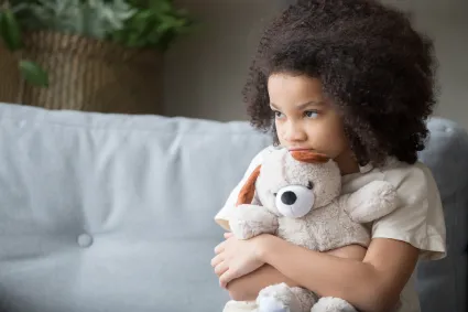 Photo of girl holding teddy bear